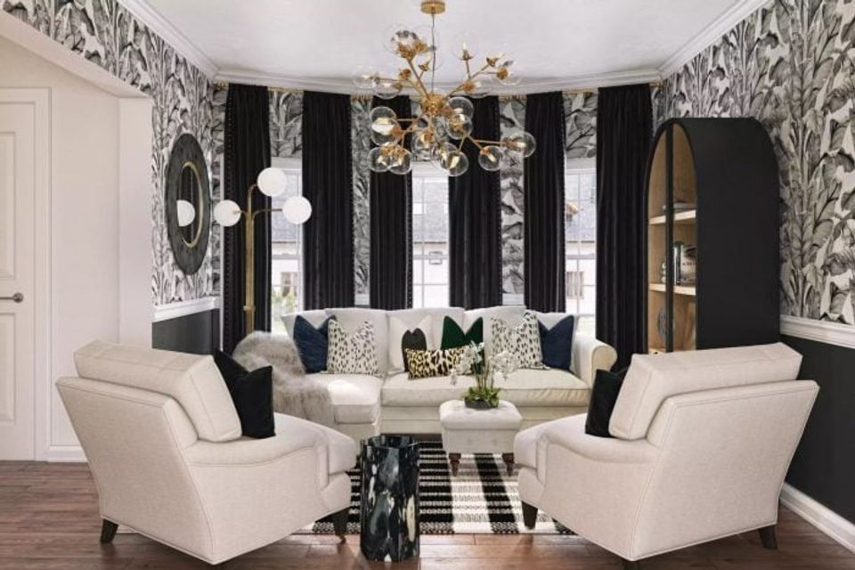 Glamorous black accent walls with patterned wallpaper, cream seating, brass fixtures, and bold geometric details in sophisticated black and white palette.