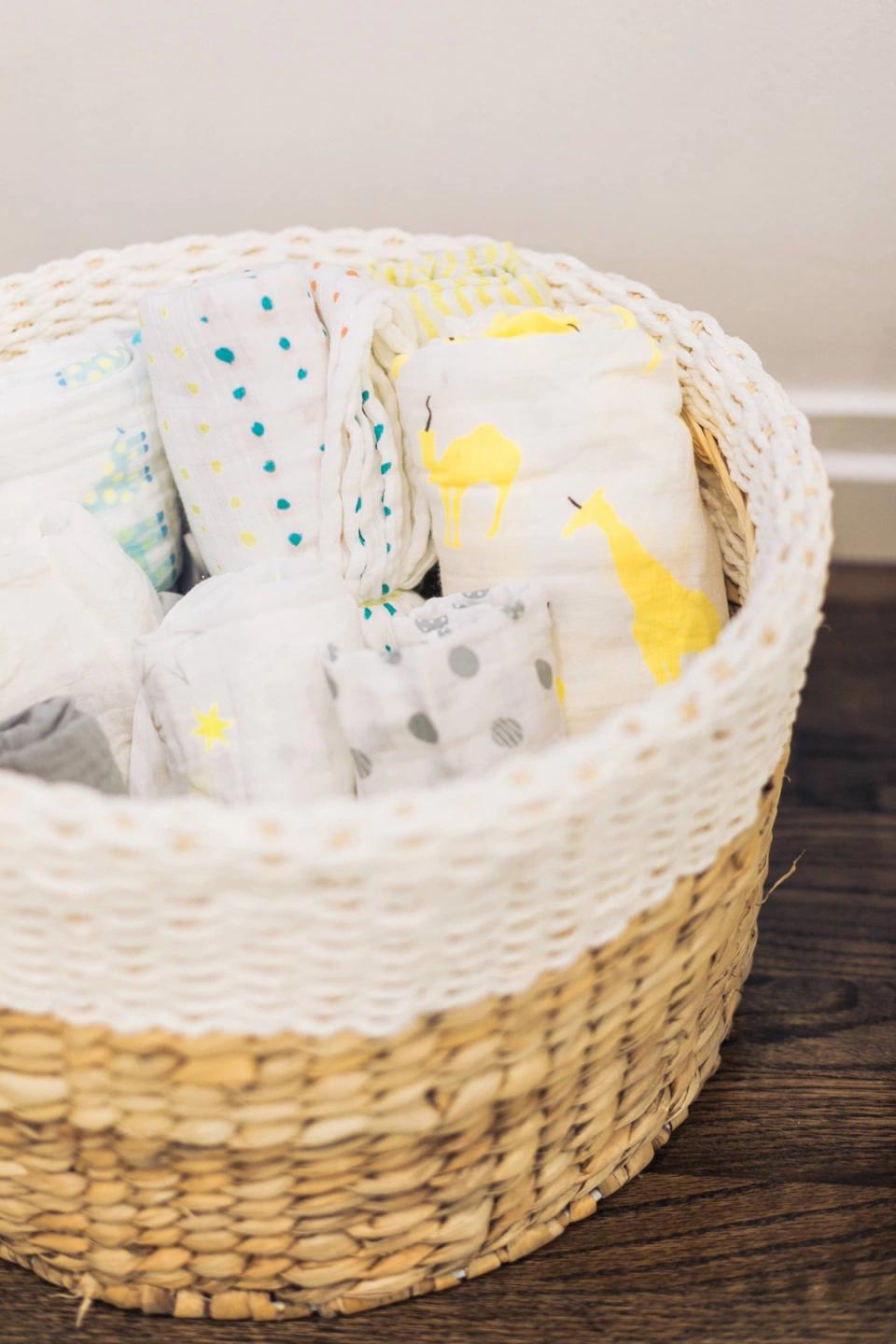 Cozy woven bassinet with soft, patterned bedding in gentle pastels and natural tones