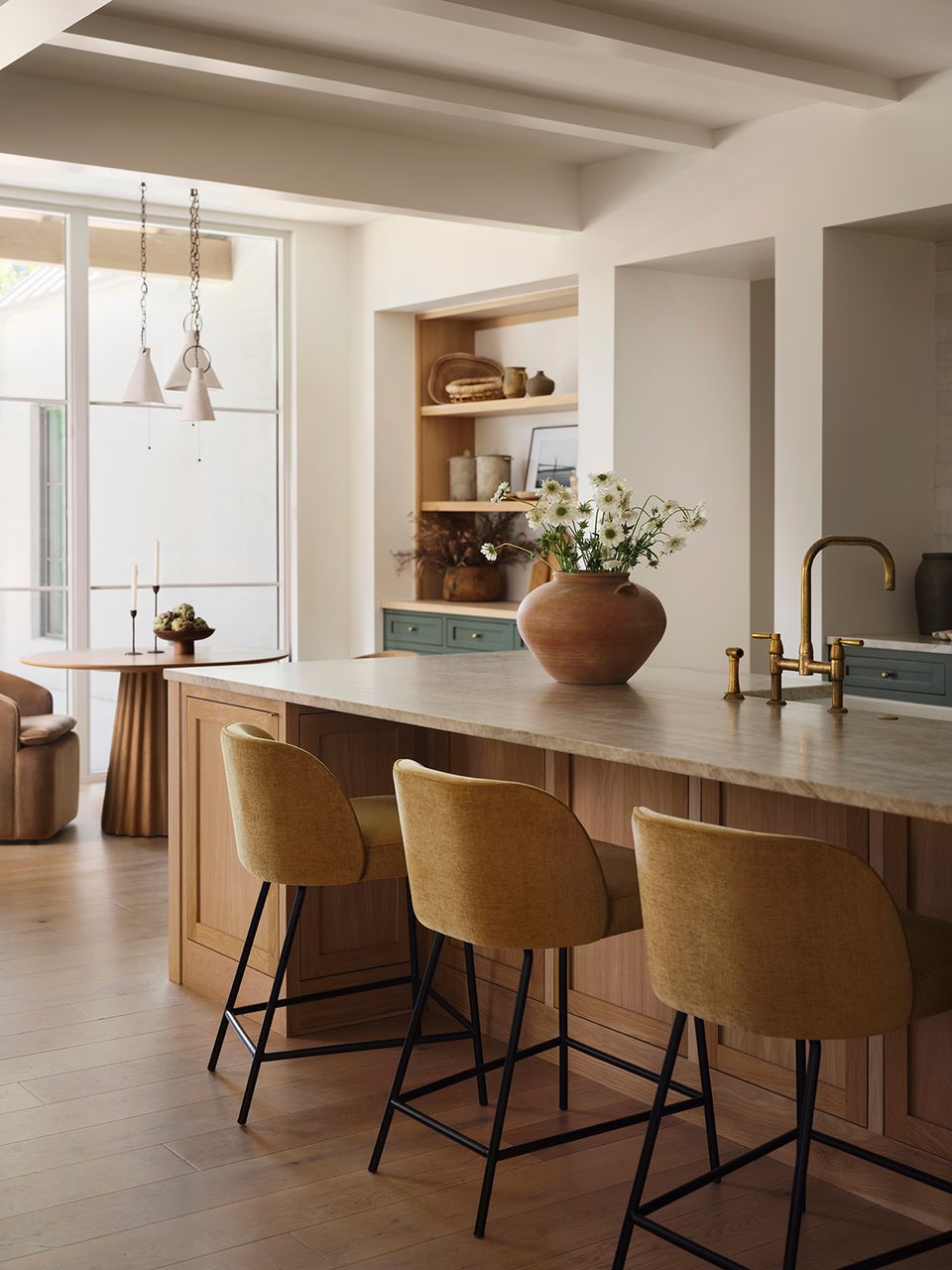 Modern farmhouse kitchen island with mustard bar stools and soft neutral tones