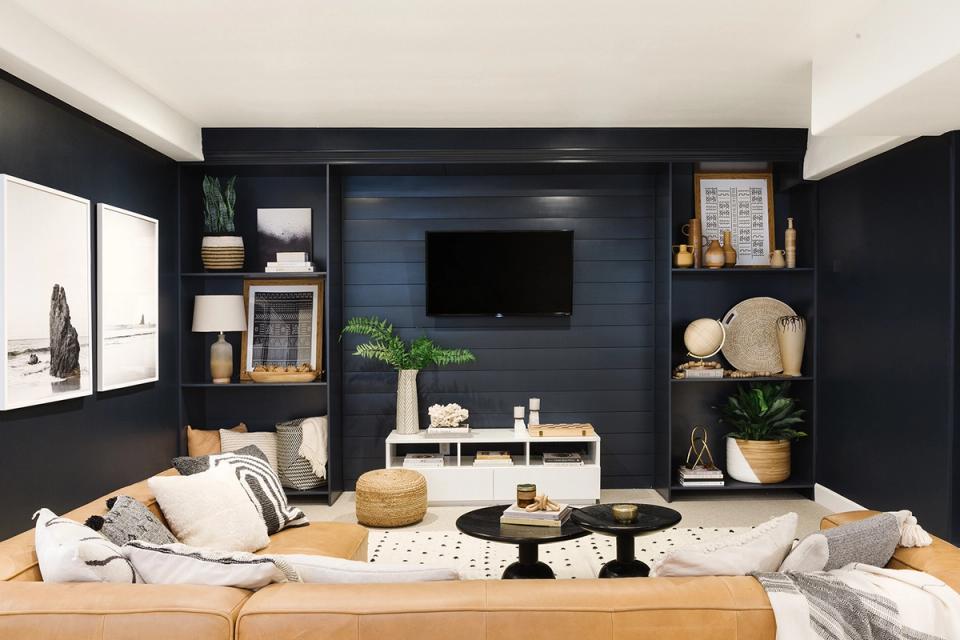 Contemporary dark navy built-in entertainment wall with open shelving and natural wood accents