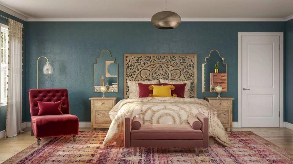 Eclectic jewel-toned bedroom with teal walls, crimson velvet chair, and woven headboard accent