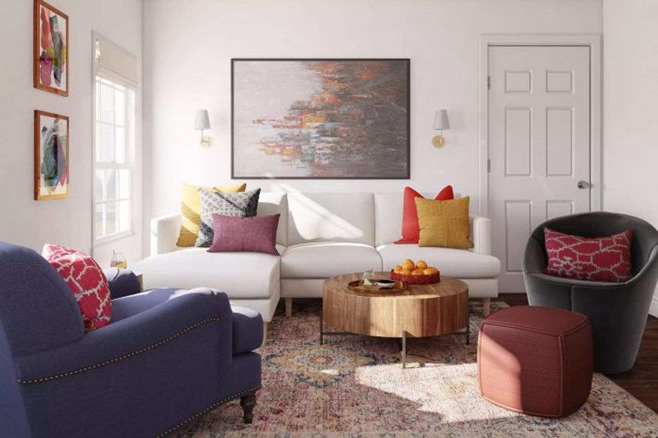 Eclectic living room blending jewel tones, colorful pillows, and vintage art pieces