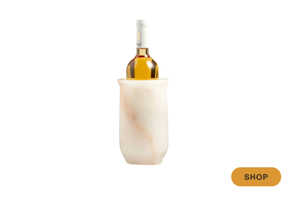 Creamy marble wine cooler with sculptural organic form and minimalist aesthetic
