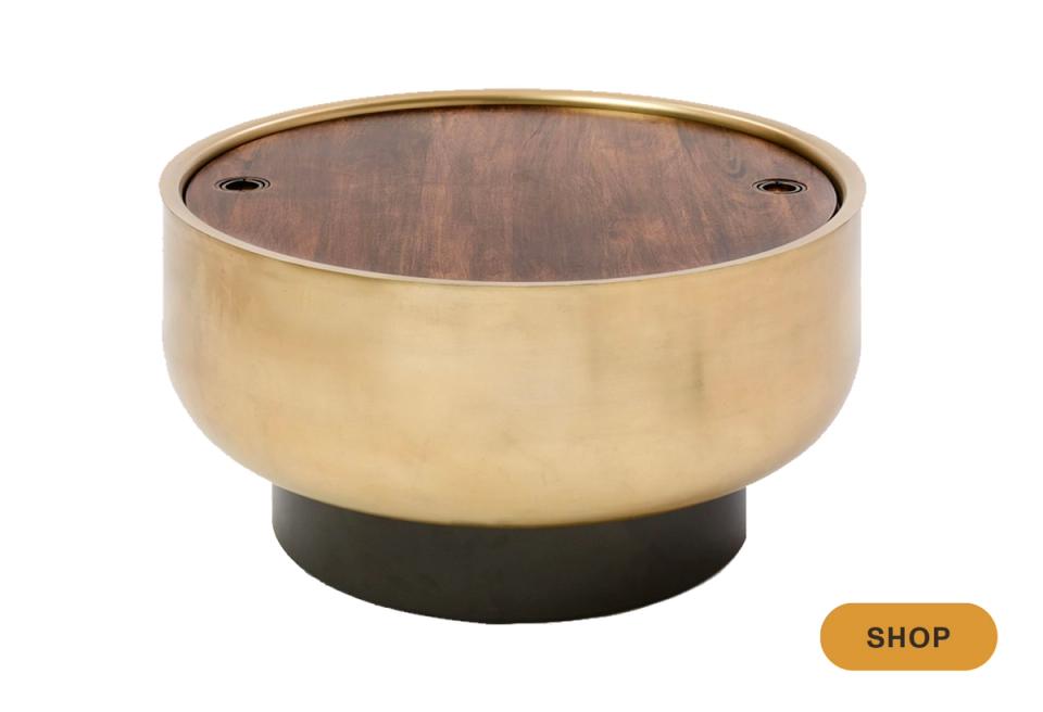Luxe round accent table with brass bowl base and dark wood top, contemporary glam