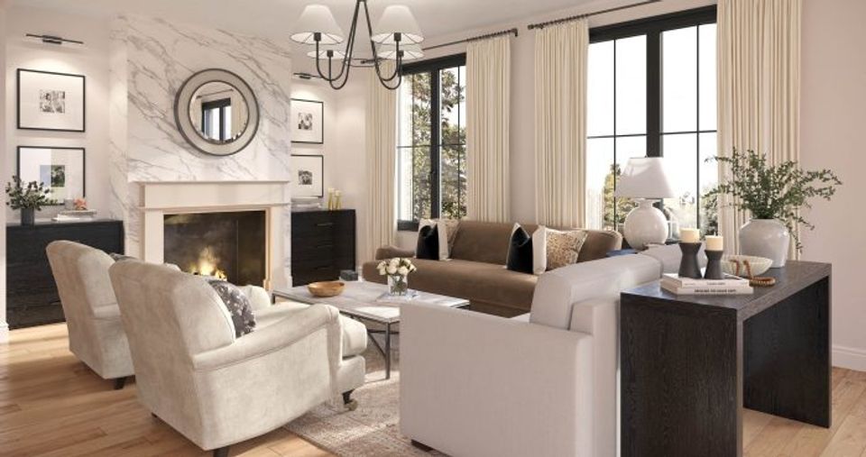 Elegant traditional living room with cream and beige palette, marble fireplace, neutral seating, and natural light from tall windows