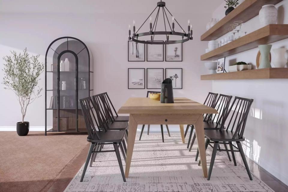 Modern farmhouse dining space with light wood table, black Windsor chairs, and pale pink walls