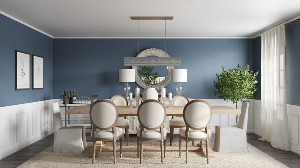Transitional dining room with soft blue walls, light wood table, and classic neutral aesthetic