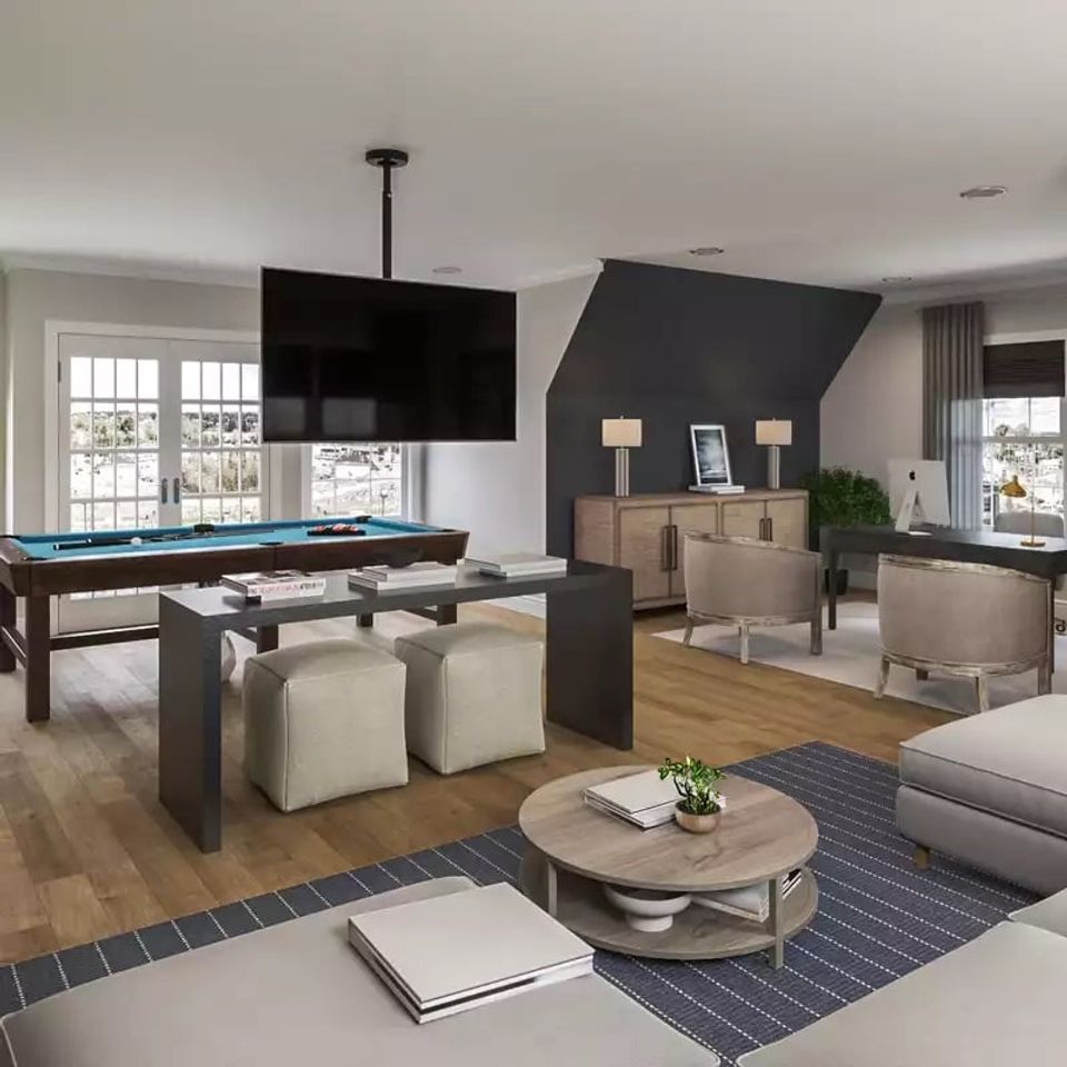 Contemporary recreation room with dark angled accent wall, warm wood tones, neutral seating, and geometric navy area rug creating sophisticated ambiance.