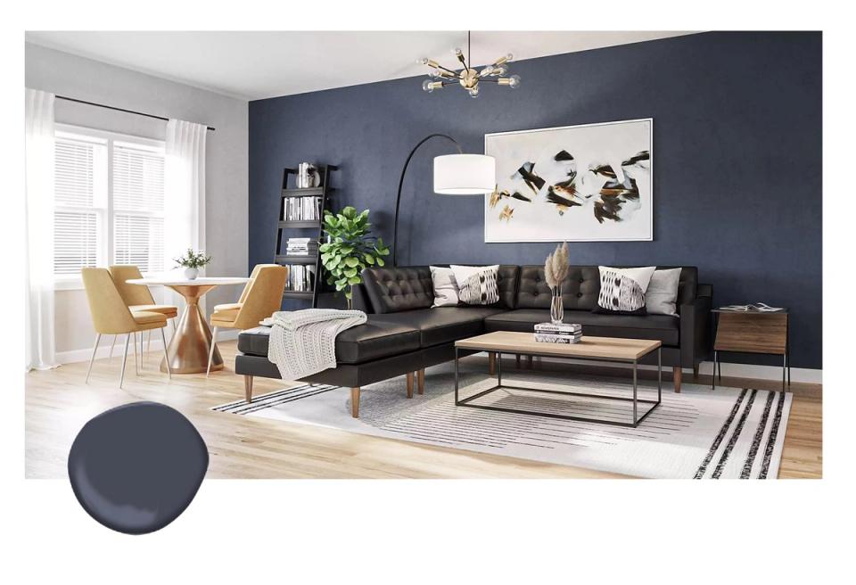 Contemporary living room pairing deep navy accent wall with warm mustard chairs and black sofa for balanced, welcoming contrast