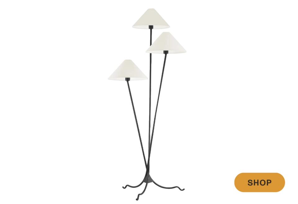 Mid-century modern floor lamp with three cream shades on splayed black metal legs