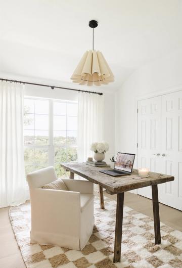 Scandinavian home office with rustic wood desk, pendant light, neutral palette