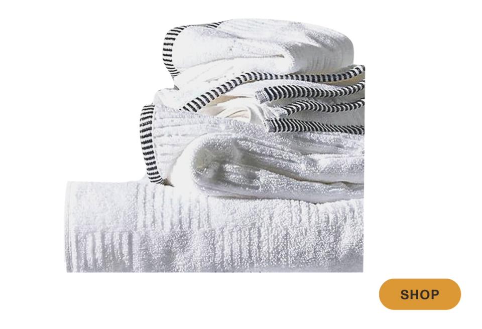 Textured white and gray towel stack with geometric stripe patterns, contemporary spa aesthetic