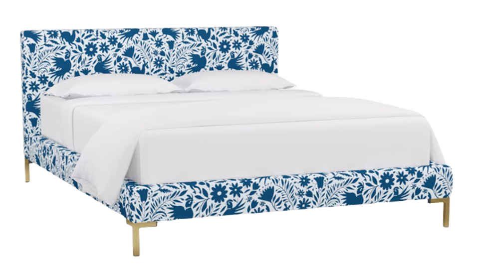 Modern bed with blue botanical upholstered headboard and footboard