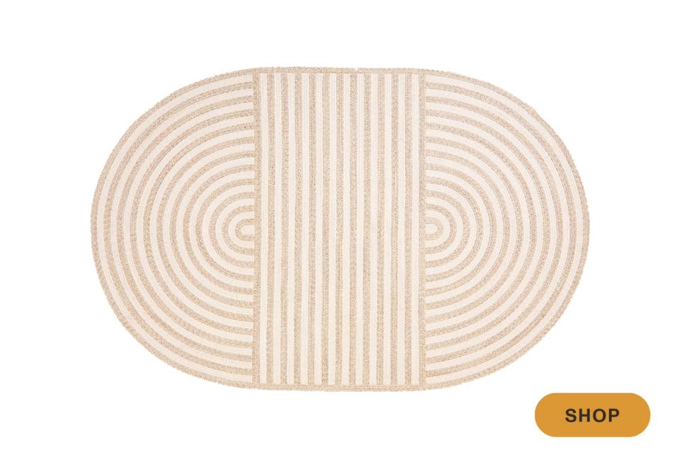 Modern abstract outdoor rug with oval shape combining circular and linear patterns in beige