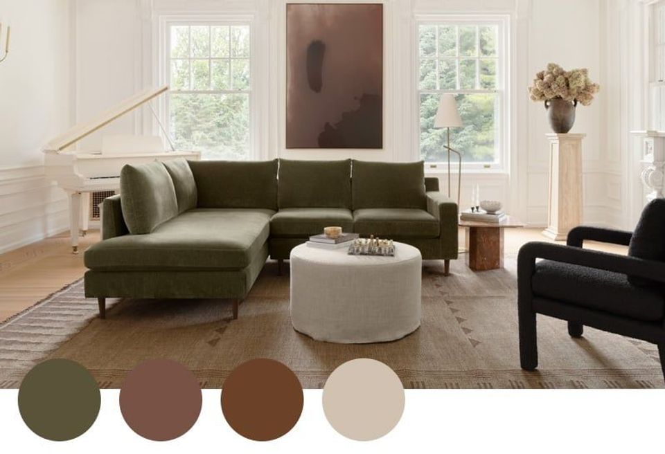 Modern living room with sage green sectional, neutral tones, and natural light creating a calm, sophisticated palette