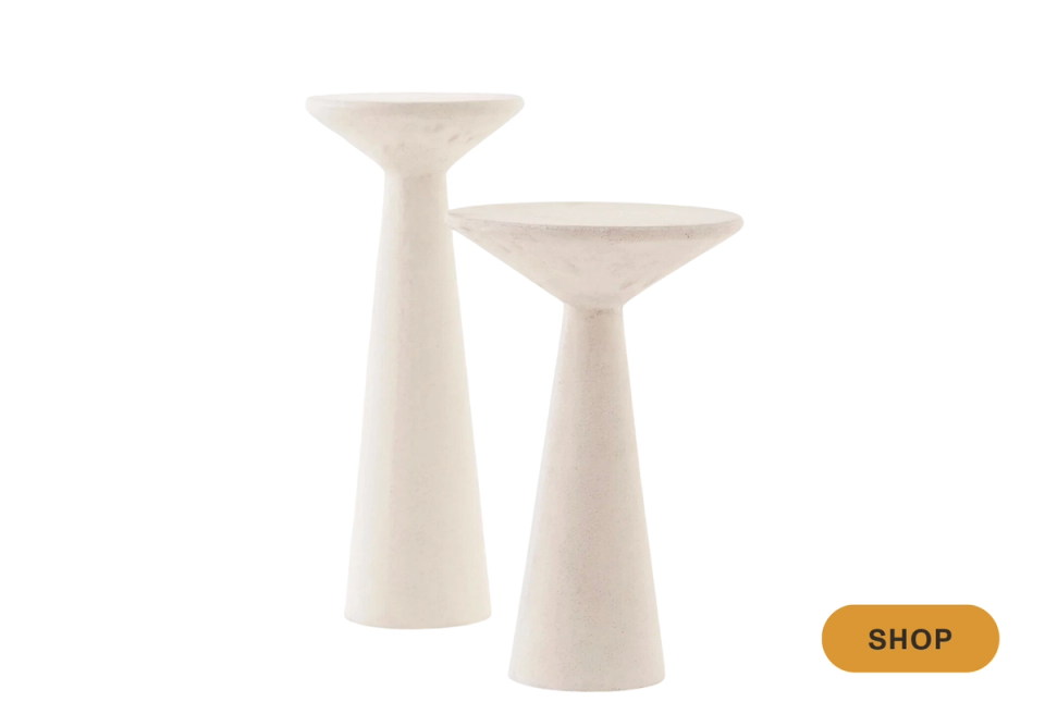 Minimalist cream ceramic martini tables with sculptural pedestal bases in soft neutral tones