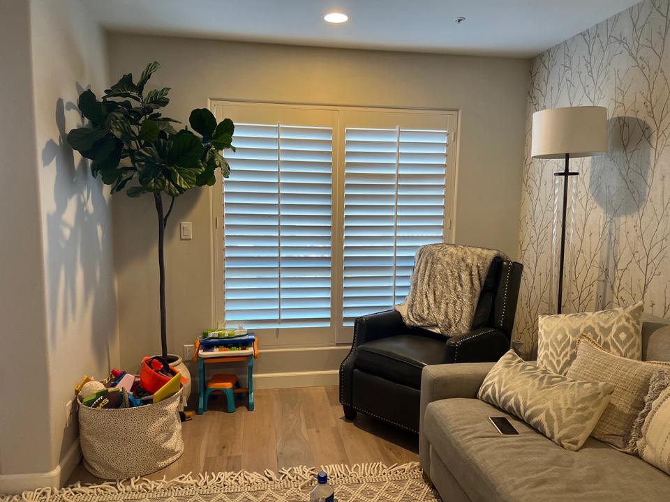 Serene transitional reading nook with neutral palette, natural light, and layered seating creating a calm, sophisticated retreat