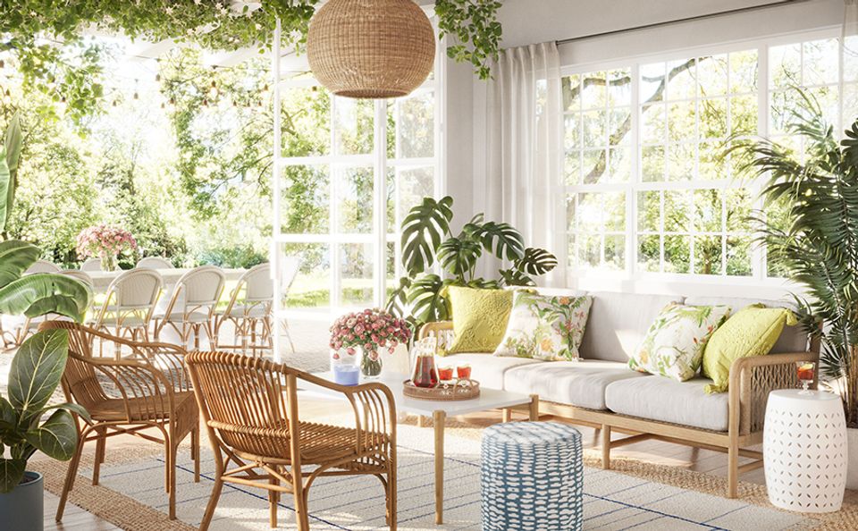 Airy sunroom with natural wood furniture, lush greenery, and breezy Scandinavian-Southern fusion