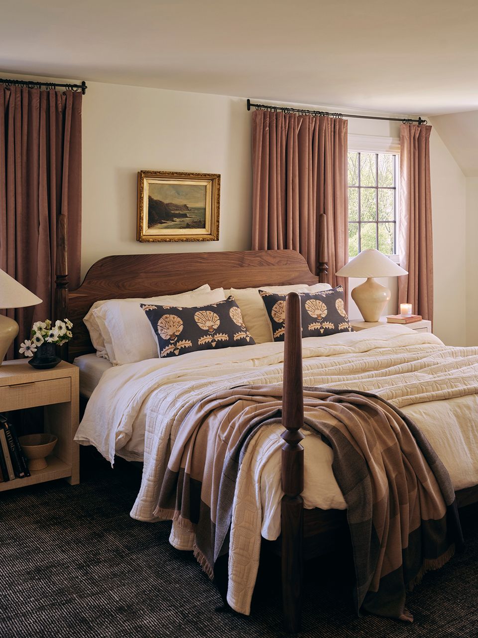 Traditional bedroom with dark wood four-poster bed, mauve drapery, and warm striped bedding
