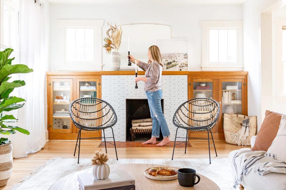Scandinavian workspace with warm wood credenza, black chairs, bright natural light, and organic accents