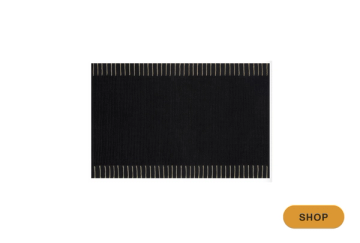 Modern minimalist black area rug with geometric striped border detail