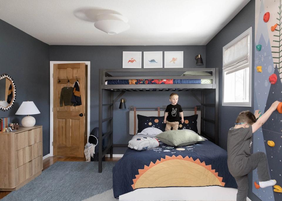 Playful navy bedroom with whimsical taco headboard, climbing features, and cozy reading nook