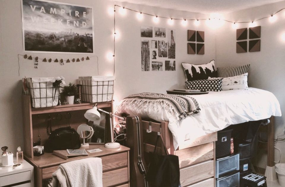 Cozy dorm bedroom with warm neutrals, string lights, and layered textures creating intimate, space-efficient design