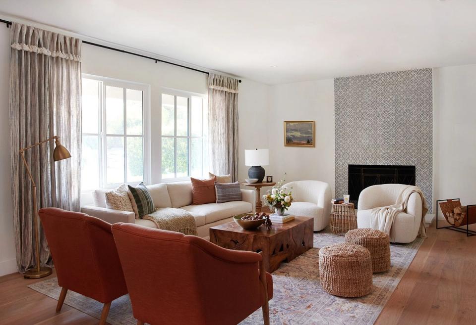 Warm contemporary living room with terracotta accents, cream upholstery, natural textiles, and soft neutral palette creating inviting comfort