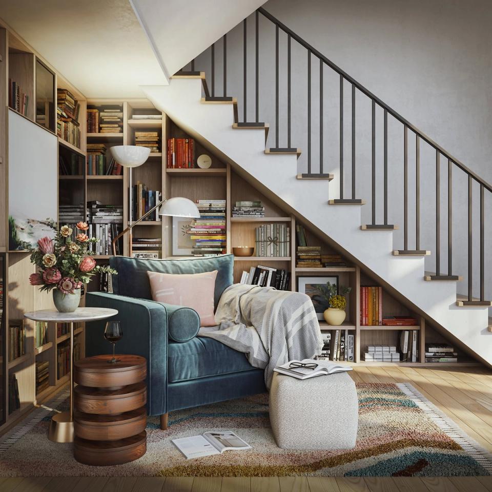 Contemporary cozy nook under staircase with teal seating, built-in shelving, warm wood, and modern simplicity.