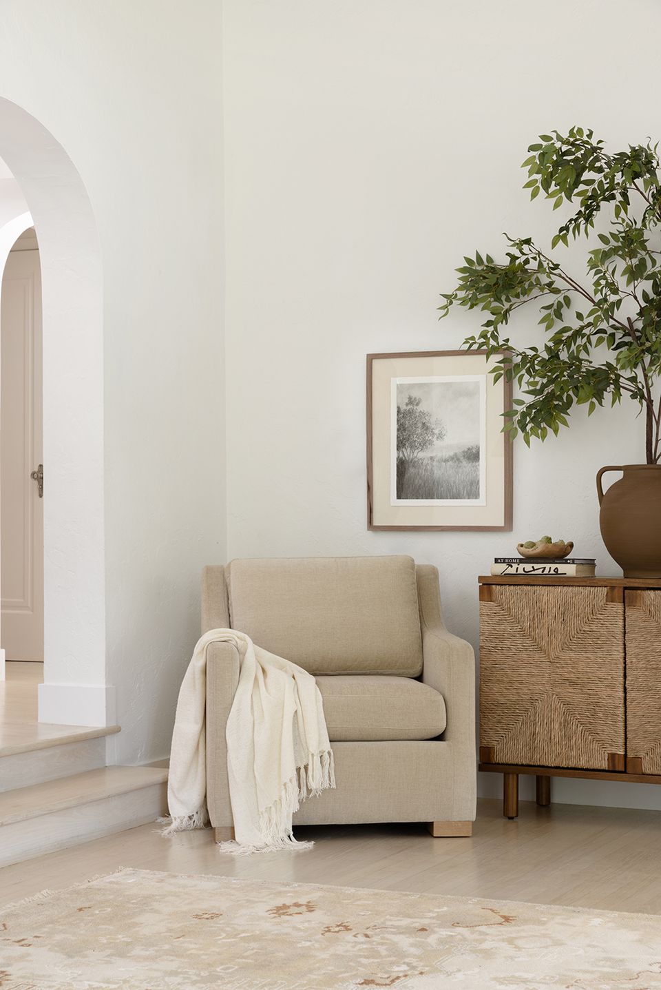 Serene Scandinavian-inspired corner with soft beige upholstery, light-filled minimalist aesthetic, and organic wood furnishings.