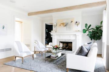 Transitional living room with exposed wood beam and fireplace