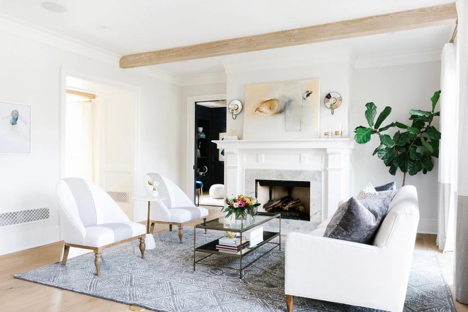 Transitional living room with exposed wood beam and fireplace