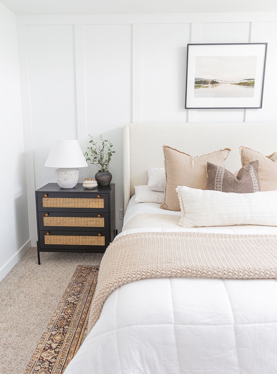 Serene minimalist bedroom with warm neutral palette, natural textures, and subtle layered bedding evoking calm, sophisticated comfort