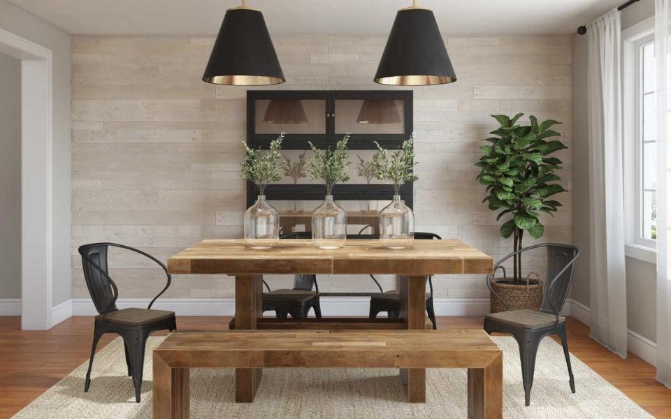 Warm rustic dining room with natural wood table, black metal pendant lights, and neutral earth-tone palette