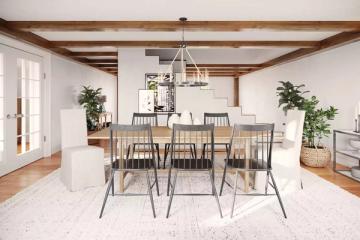 Contemporary farmhouse dining room with exposed beams, light wood table, and industrial pendant light