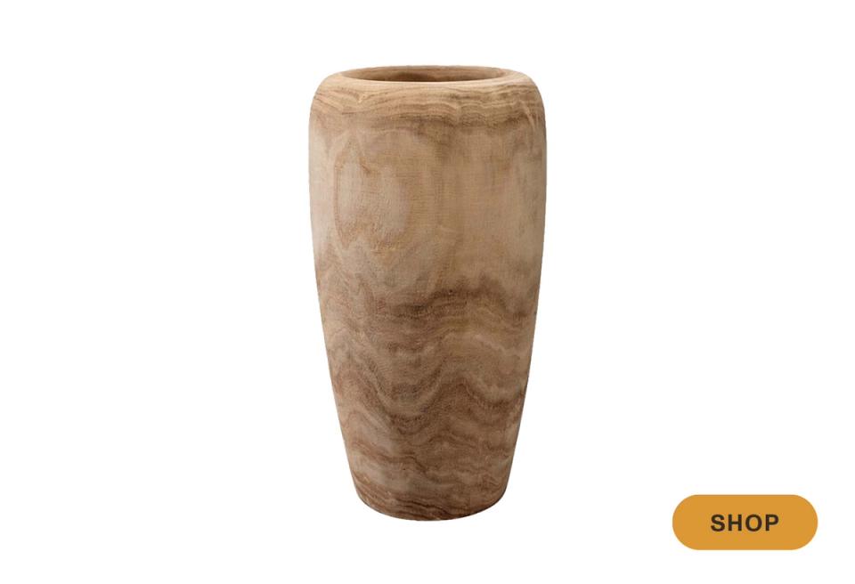 Hand-carved wooden vessel with natural grain texture in warm tan and brown tones, artisanal craftsmanship
