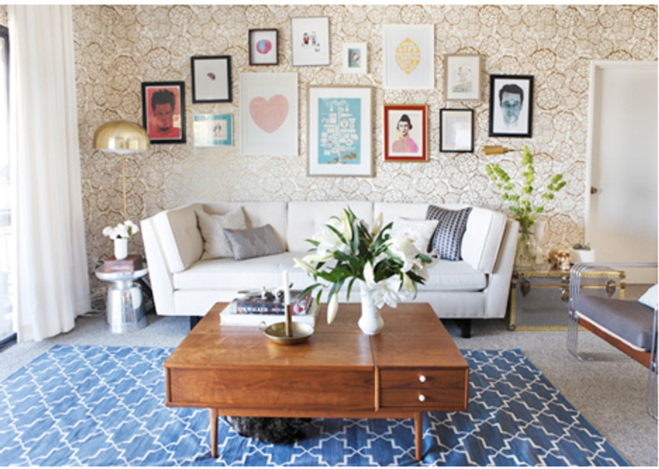 Scandinavian living room with cork wallpaper, white sofa, and geometric patterned carpet