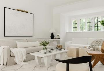 Minimalist room with large framed white canvas art and neutral furnishings creating calm aesthetic