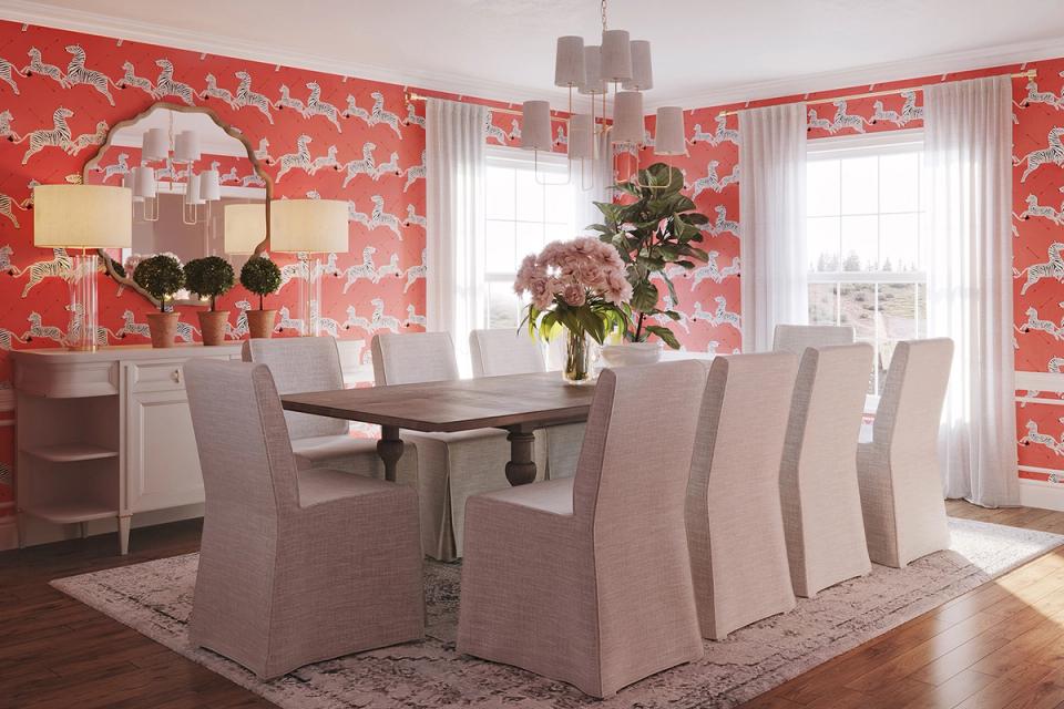 Bold coral wallpaper with Asian-inspired pattern creates vibrant dining room with neutral upholstered chairs