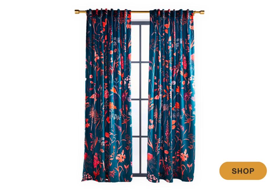 Navy curtains with vibrant red and teal floral botanical pattern on brass rod