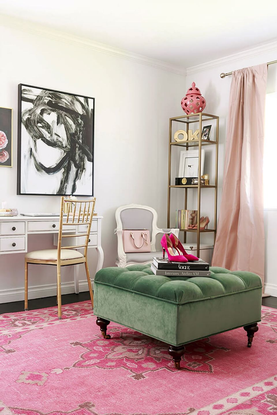 Eclectic femme office with sage green ottoman, blush curtains, and bold graphic art, playful palette