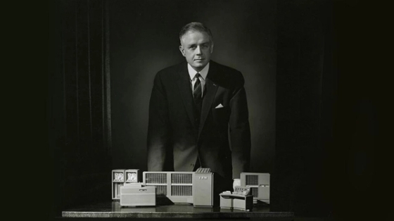 Thomas J Watson with an IBM design in front of him