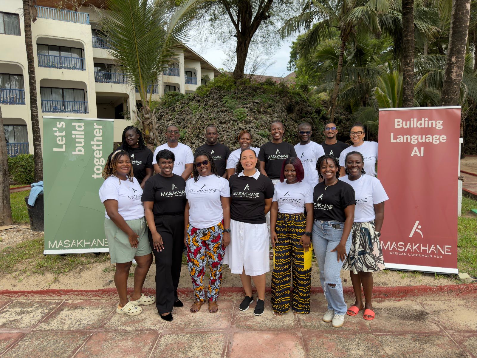 Group photo of Masakhane staff and board in branded t-shirts