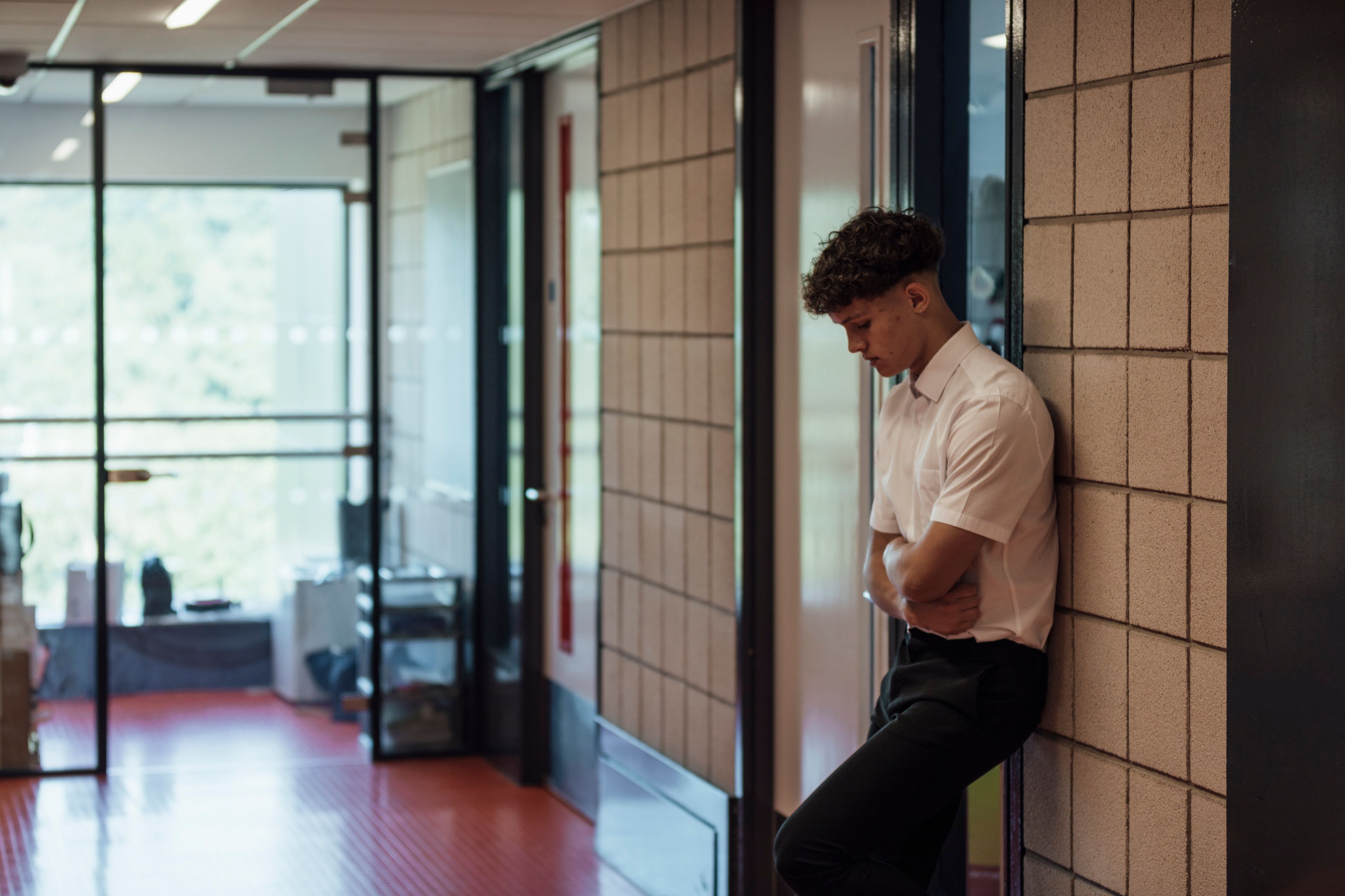 Boy outside classroom.