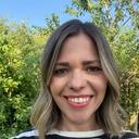 Finding Therapy counsellor Helen Spiers, smiling outdoors in front of a garden hedge