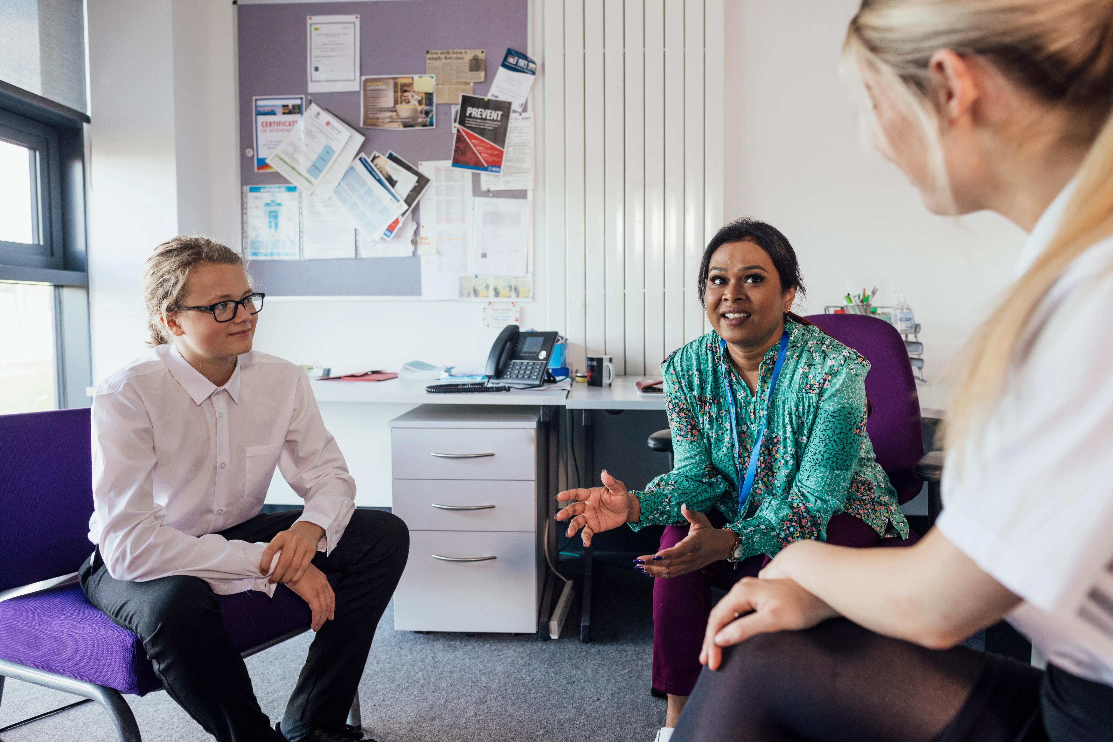 A meeting in a school office, between teacher, student and parent
