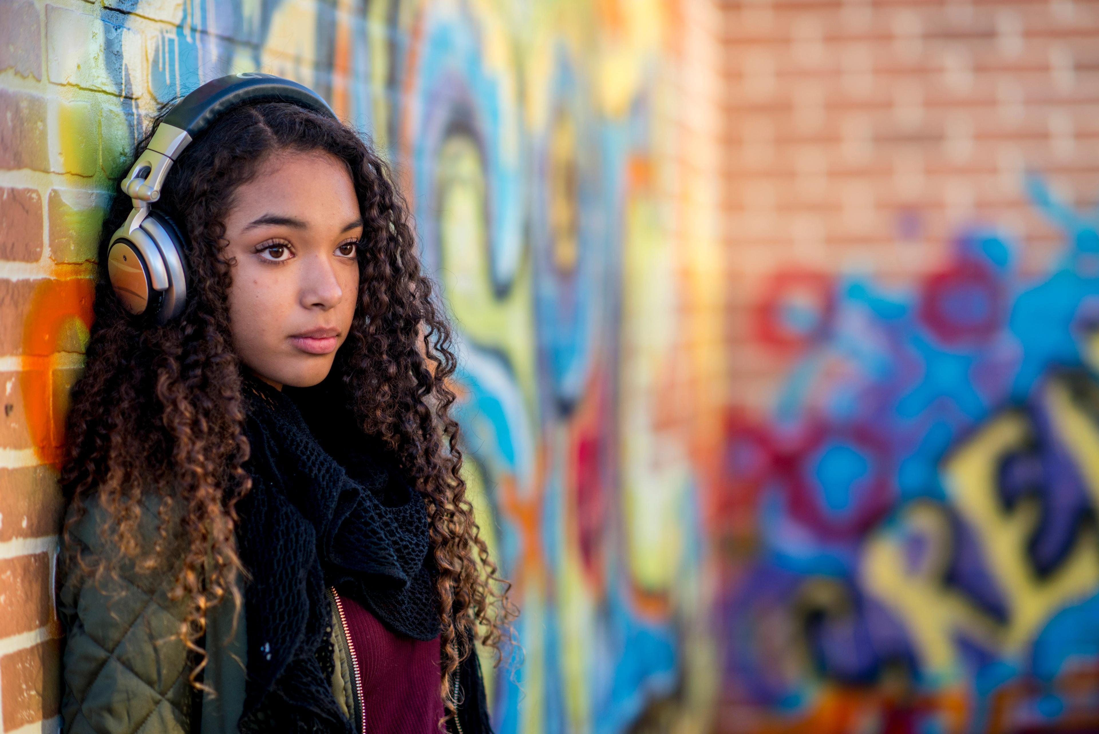 A teenage girl with headphones on