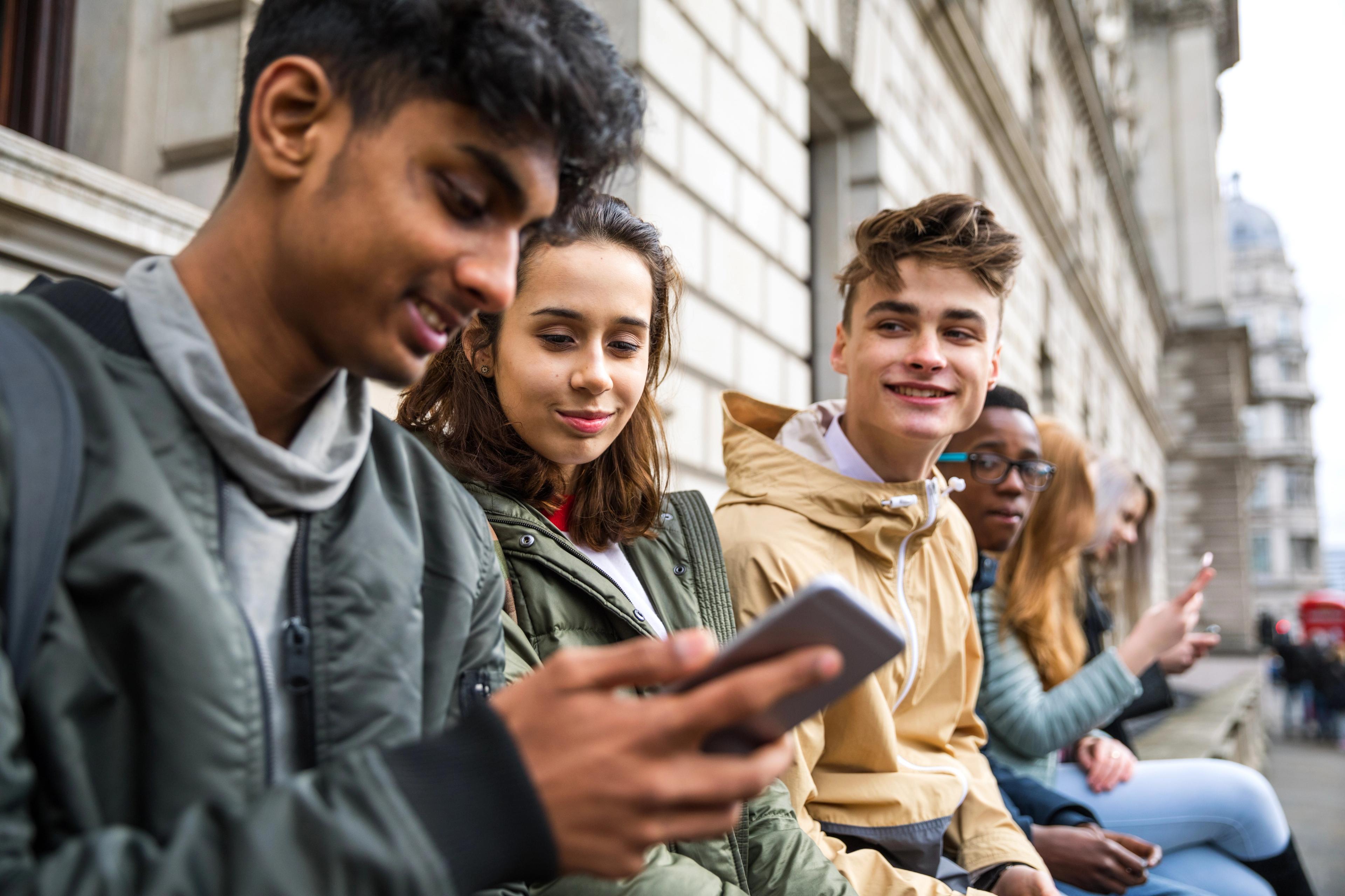 A group of teenagers are laughing together