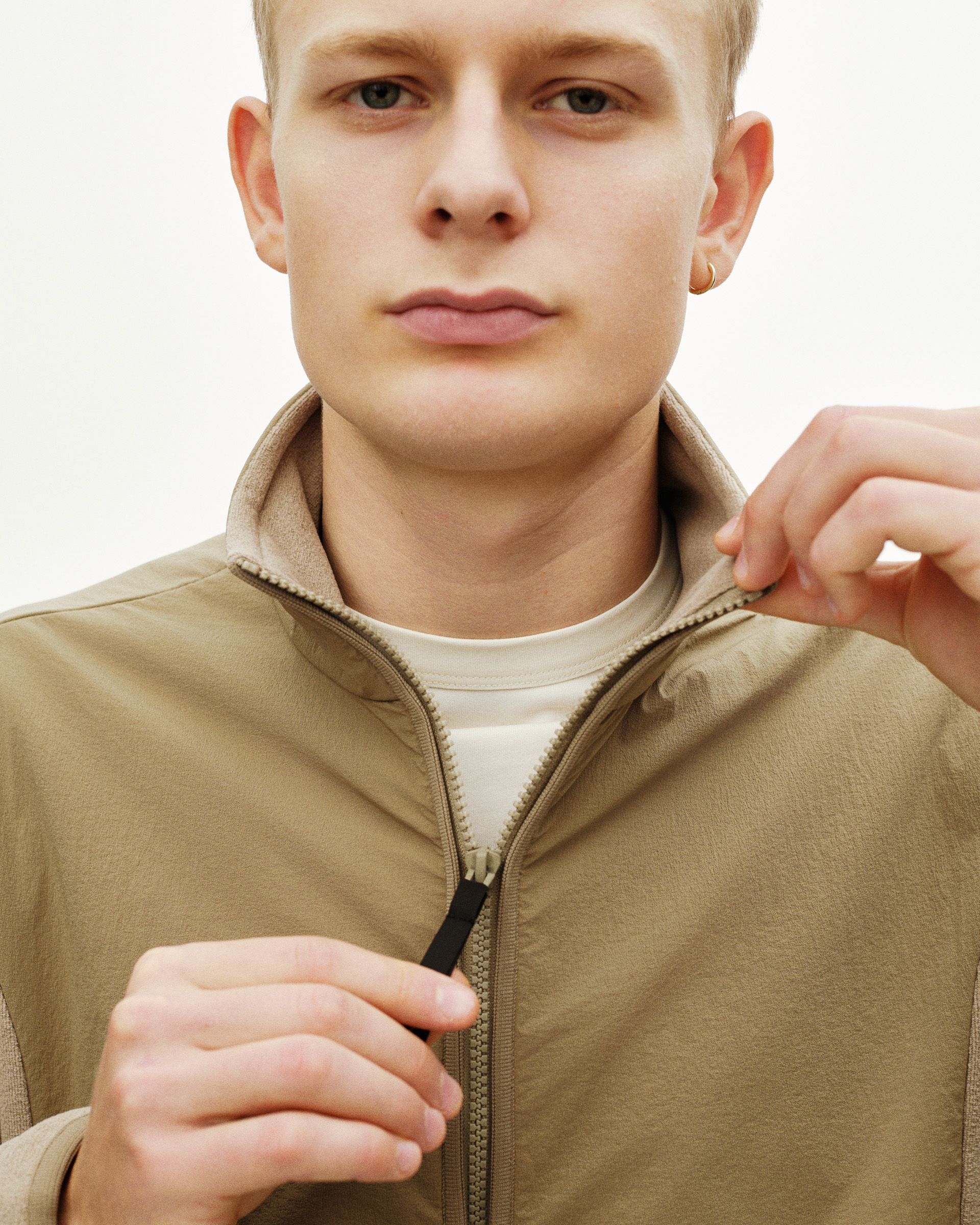 Beige Off-Race Light Fleece half-zip on model with black zip pull