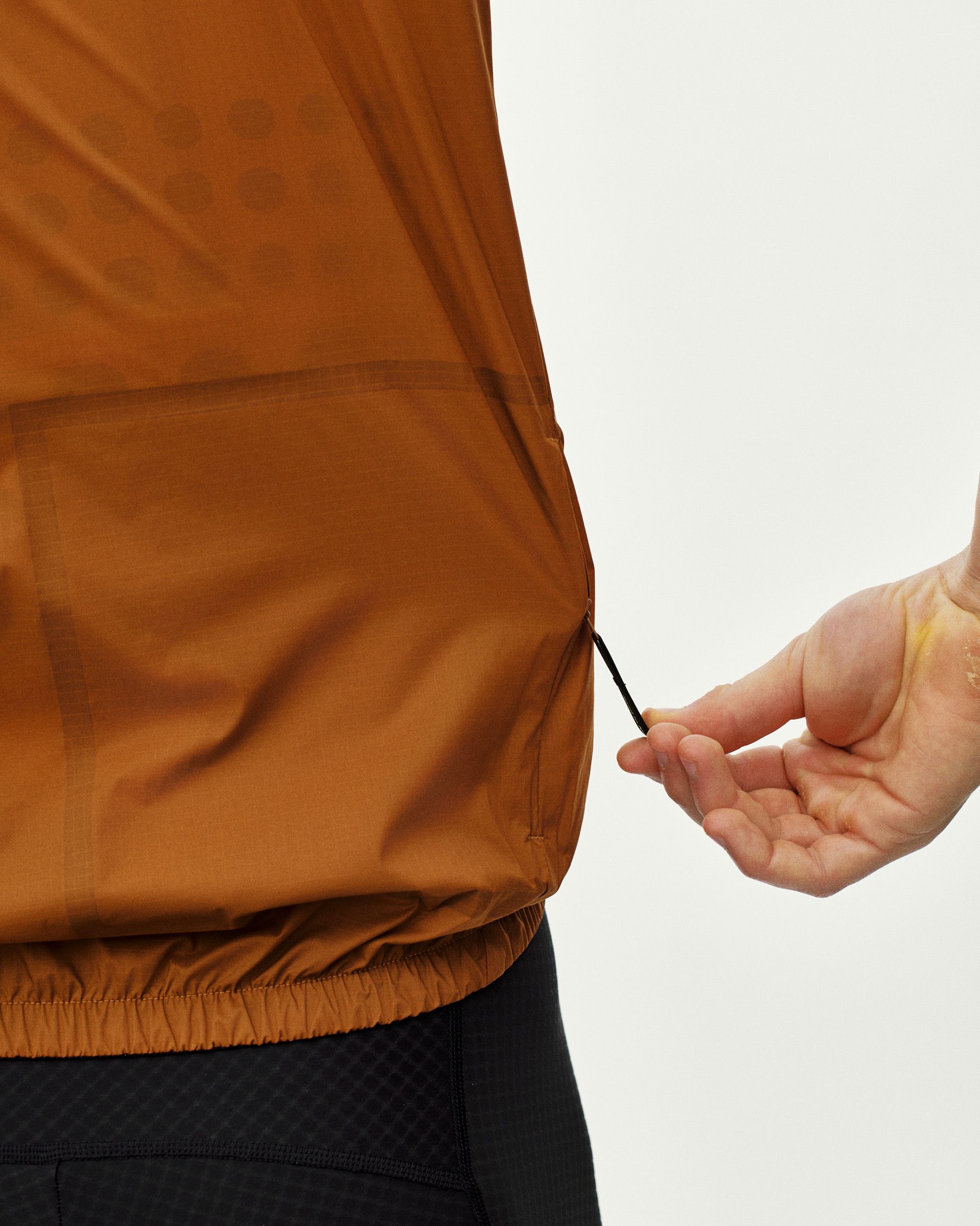 Brown Essential Insulated gilet on model, rear detail view showing elastic hem and drawstring adjustment